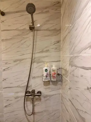 a shower with a shower head in a bathroom at Spacious room in Sukhumvit Nana in Bangkok