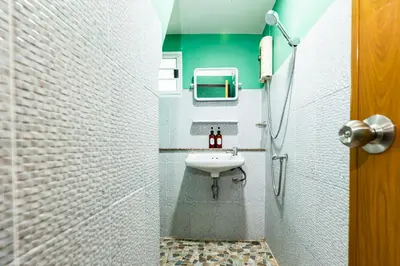 a bathroom with a sink and a shower at xx GO INN The Giant Swing โก อินน์ เสาชิงช้า in Bangkok