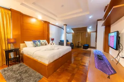 a bedroom with a bed and a flat screen tv at Mak Sukhumvit 15 in Bangkok