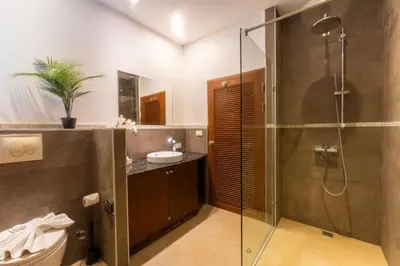 a bathroom with a shower and a sink at Mak Sukhumvit 15 in Bangkok