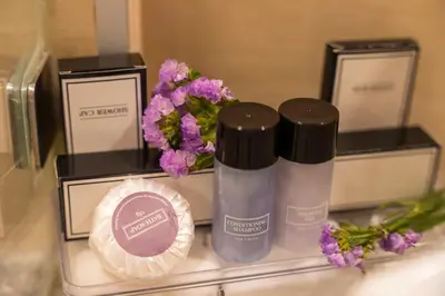 a group of products sitting on a shelf with flowers at Mak Sukhumvit 15 in Bangkok