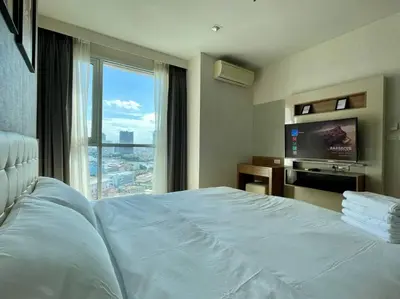 a hotel room with a bed and a large window at Opulence Riverview with Train Access in Bangkok