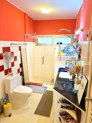 a bathroom with a toilet and red walls at Entire House 6 people 3Beds 2Baths near BTS Asoke Terminal21 in Bangkok