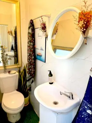 a bathroom with a sink and a toilet and a mirror at Entire House 6 people 3Beds 2Baths near BTS Asoke Terminal21 in Bangkok