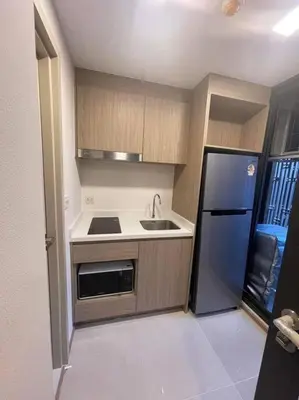 a small kitchen with a sink and a refrigerator at Luxury and cozy apartment in the City center in Bangkok