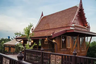 a small house with a fence in front of it at เรือนไทยพราวพิมาน Proudpiman Thai Heritage House in Ban Bang Toei (1)