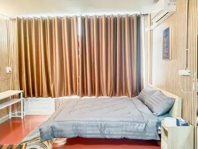 a bedroom with a bed in front of a large window at Moochi Relax L'Assommior in Bangkok
