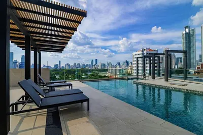 a pool on the roof of a building at Cosy apartment - BTS Phrom phong in Bangkok