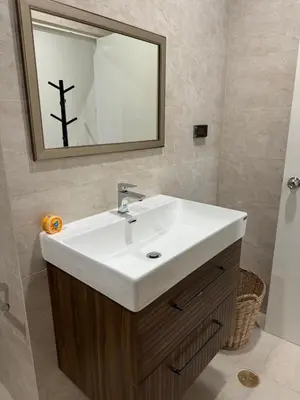 a bathroom with a white sink and a mirror at EM HOME Sukhumvit Bangkok - near Terminal 21, EM District Malls, BTS and MRT Lines in Bangkok
