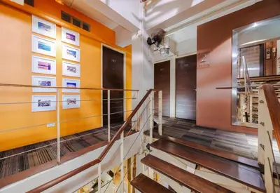 a staircase in a building with orange walls at Collection O Diamond House Khaosan in Bangkok