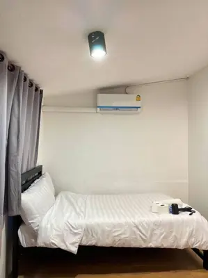 a bedroom with a white bed in a room at Chubbi 5 Room10 in Bang O