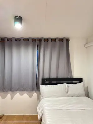 a bedroom with a white bed and a window at Chubbi 5 Room10 in Bang O