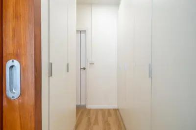 a room with white walls and a hallway with a door at 4BR Walk to Chinatown, MRT Luggage Dropoff in Bangkok