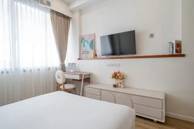 a hotel room with a bed and a tv on the wall at 4BR Walk to Chinatown, MRT Luggage Dropoff in Bangkok