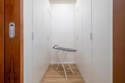 a stool in a room with a white wall at 4BR Walk to Chinatown, MRT Luggage Dropoff in Bangkok