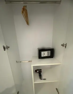 a small radio sitting on a shelf in a bathroom at Icon Dome Bangkok in Bangkok
