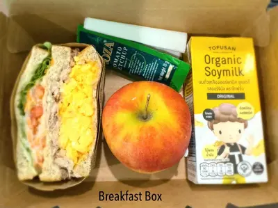 a box with an apple and a sandwich and some food at Icon Dome Bangkok in Bangkok