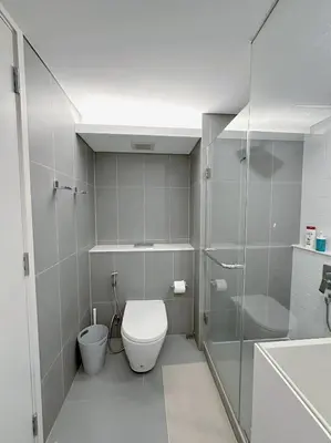 a bathroom with a toilet and a shower and a sink at Luxury loft with Stunning 35th Floor Views in Bangkok