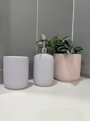 a group of three plants and a soap dispenser on a counter at Luxury loft with Stunning 35th Floor Views in Bangkok