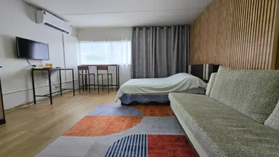 a hotel room with a couch and a bed at อิมแพ็ค เมืองทองธานี ห้องพักรายวัน Popular Condo T8 in Nonthaburi