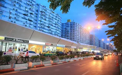a city street with cars parked in front of buildings at อิมแพ็ค เมืองทองธานี ห้องพักรายวัน Popular Condo T8 in Nonthaburi