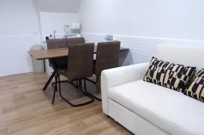 a living room with a table and a couch at Oskar's House in Bangkok