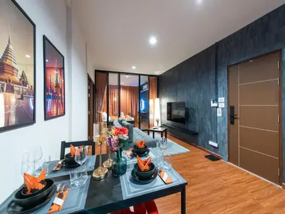 a living room with a table with flowers on it at The City Yaowarat in Samphanthawong