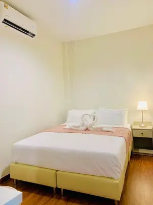 a bedroom with a bed with a towel on it at The City Yaowarat in Samphanthawong