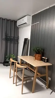 a wooden table and two chairs in a room at Popular Muang Thong Thani Condo, Building T9, Floor 8, Room 13 in Pak Kret