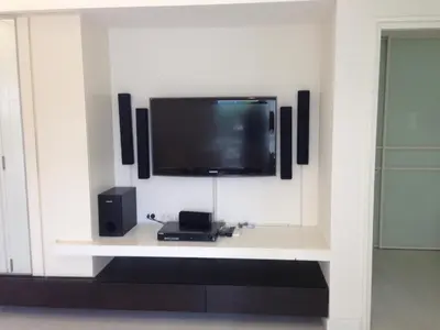 a flat screen tv on a wall with speakers at Condo near Iconsiam The Bangkok Sathorn-Taksin Corner Room in Godown