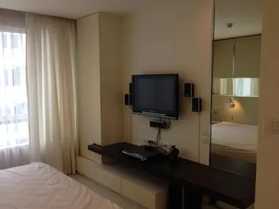 a hotel room with a television and a bed at Condo near Iconsiam The Bangkok Sathorn-Taksin Corner Room in Godown