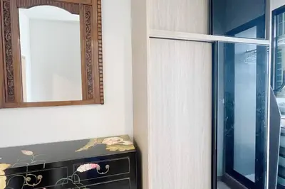 a mirror and a dresser in a room at Niche Mono 2 Bedroom next to BTS Bearing in Samut Prakan