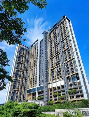a large building with two tall buildings at Niche Mono 2 Bedroom next to BTS Bearing in Samut Prakan