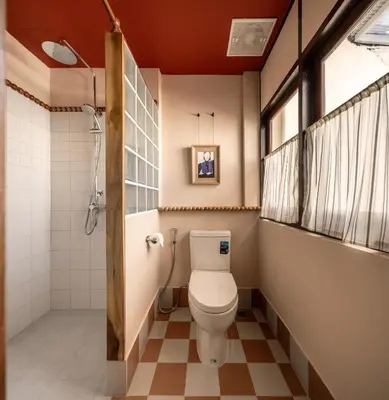 a bathroom with a toilet and a shower at Blu Dock Restel Bangkok in Bangkok