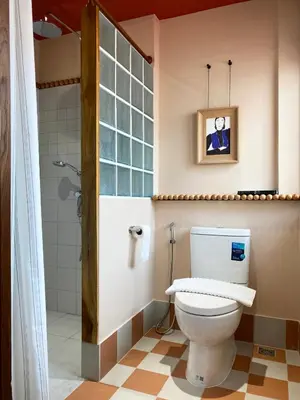 a bathroom with a toilet and a shower at Blu Dock Restel Bangkok in Bangkok
