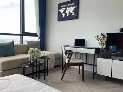 a living room with a couch and a desk with a computer at Luxurious River View chao phraya river in Bangkok