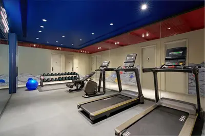 a gym with two treadmills and two exercise bikes at Riva Vibe Hotel Bangkok by PCL in Bangkok