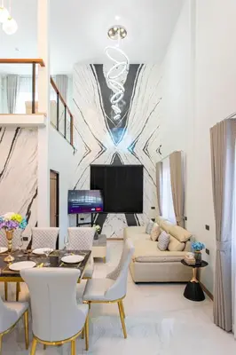a living room with a couch and a tv at Psalms 23 Residence in Bangkok