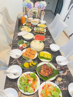 a long table with plates of food on it at Psalms 23 Residence in Bangkok