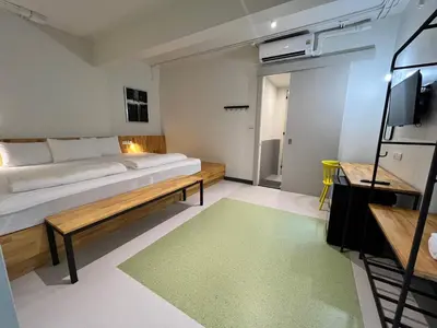 a bedroom with a large bed and a green rug at Hello my friend in Bang Bua Thong Railway Station