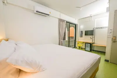 a bedroom with a large white bed in a room at Hello my friend in Bang Bua Thong Railway Station
