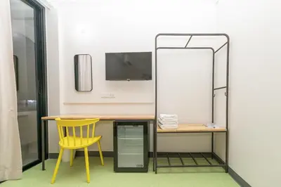 a desk with a yellow chair and a mirror at Hello my friend in Bang Bua Thong Railway Station