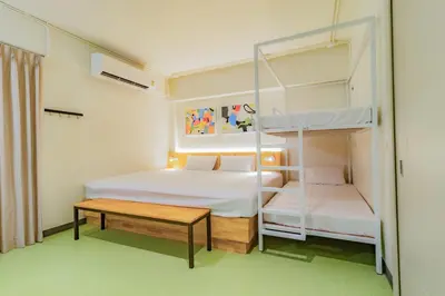 a small room with two bunk beds and a table at Hello my friend in Bang Bua Thong Railway Station