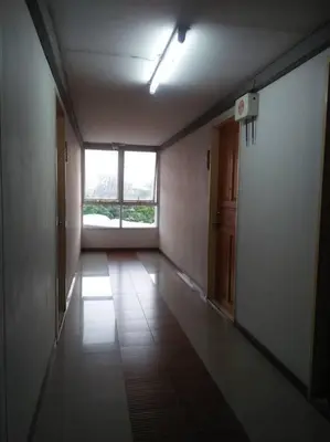 an empty hallway with a large window in a building at Cozy 1 Bedroom Apartment Close by Ratchada in Bangkok