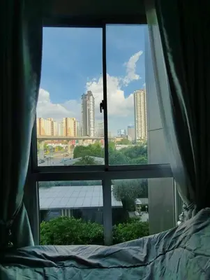 a view of a city from a bedroom window at Fully Furnished Apartment Close to MRT Pool n Gym in Nonthaburi