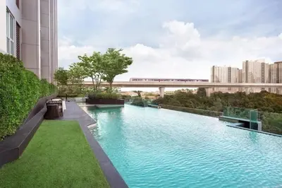 a swimming pool in the middle of a building with a train at Fully Furnished Apartment Close to MRT Pool n Gym in Nonthaburi