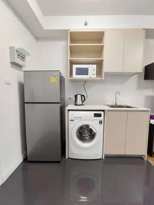 a kitchen with a refrigerator and a washing machine at Fully Furnished Apartment Close to MRT Pool n Gym in Nonthaburi