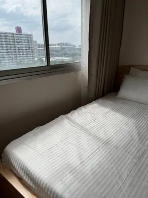 a bed in a room with a window at OpenView เมืองทอง T1 Impact Muang Thong Thani in Nonthaburi
