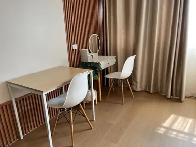 a room with a table and two chairs and a mirror at OpenView เมืองทอง T1 Impact Muang Thong Thani in Nonthaburi