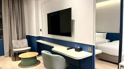 a hotel room with a bed and a tv at The Quarter Ramkhamhaeng by UHG in Bangkok